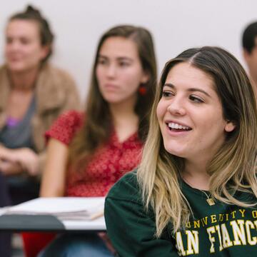 Group of students at their desks in a classroom.